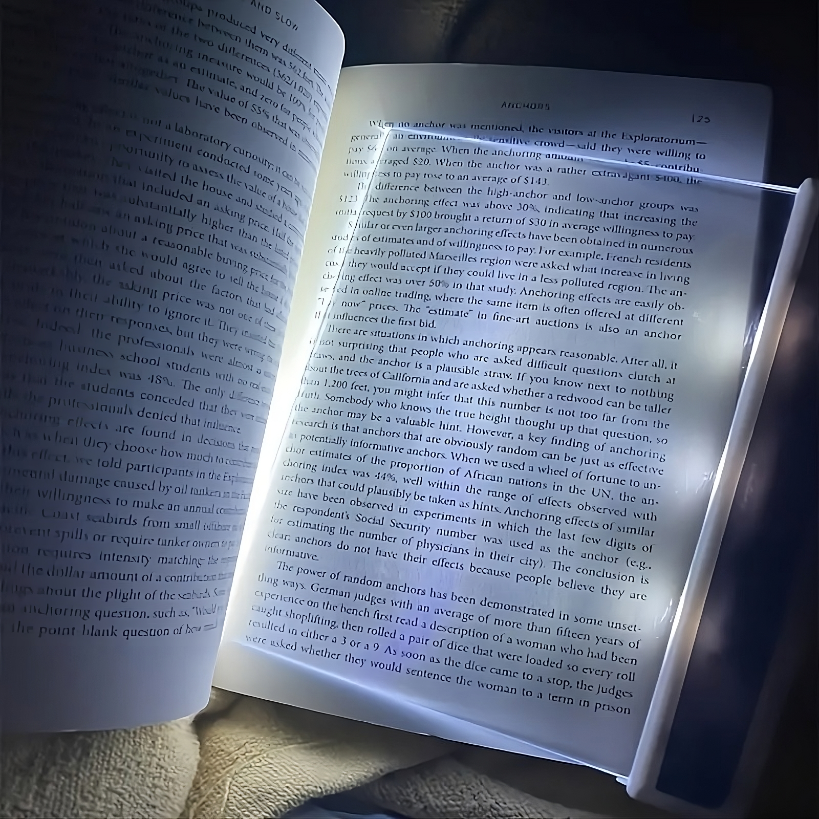 book light turned on and being used on a dim page