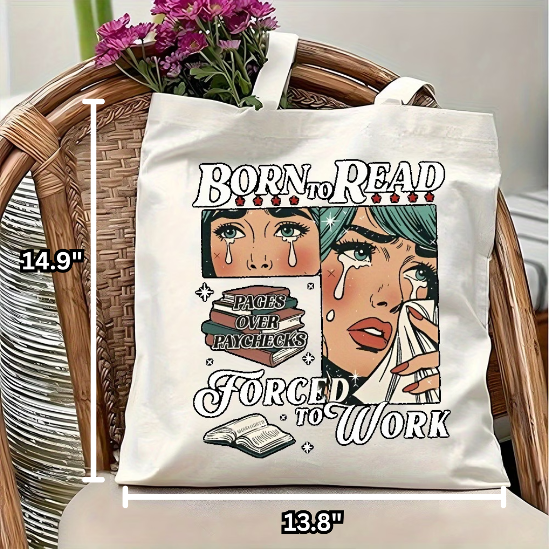 Tote bag with 'Born to Read, Forced to Work' design on a chair with flowers.
