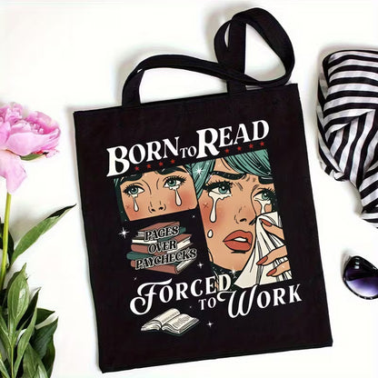 Black tote bag on a white surface with other props nearby for size reference